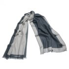 Gray and dark blue scarf with fringed edges, laid out flat on a white background.