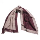 A beige and burgundy scarf with fringed edges, loosely knotted on a white background.