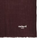 A burgundy scarf with cacharel PARIS embroidered in white near the edge.