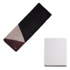 A folded geometric scarf next to a plain white box on a white background.