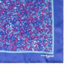 Blue Cacharel scarf with a purple, blue, and white floral pattern and a solid blue border.