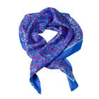 Blue and pink patterned silk scarf with a blue border, folded in a loose loop.