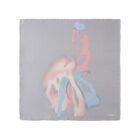 A gray silk scarf with abstract pastel shapes in pink, blue, and cream tones.