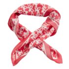 Pink and white patterned silk scarf with a floral design, arranged in a loose knot.