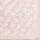 Light pink scarf with white abstract pattern and cacharel logo in the corner.