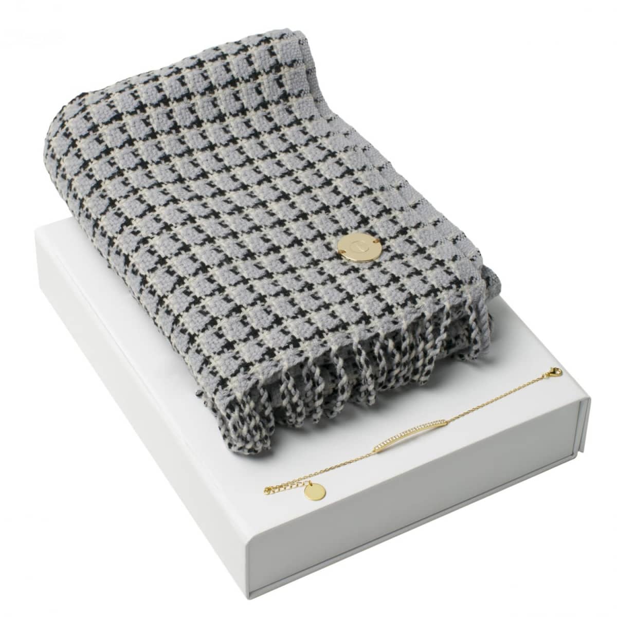 Gray checkered scarf and gold bracelet displayed on a white box.