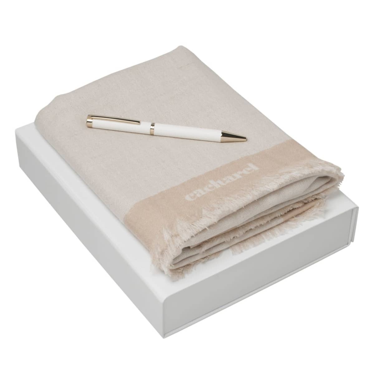 A beige scarf and white pen placed on top of a white box.