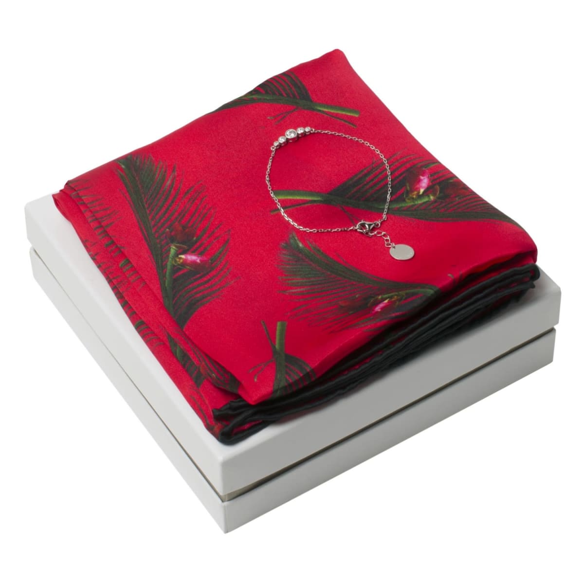 Red floral scarf and silver bracelet displayed on a white gift box.
