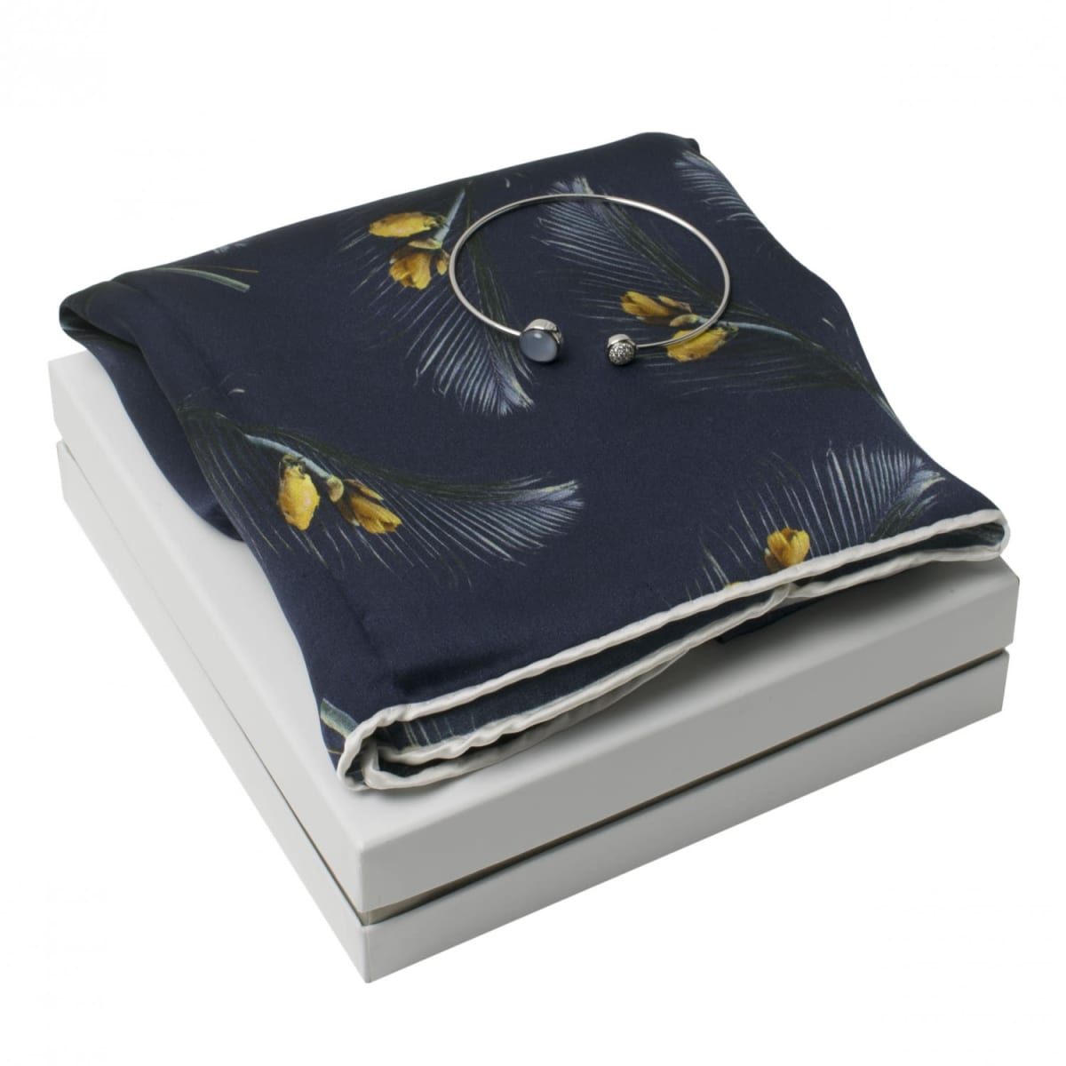 Navy floral scarf and silver bracelet on a white gift box.