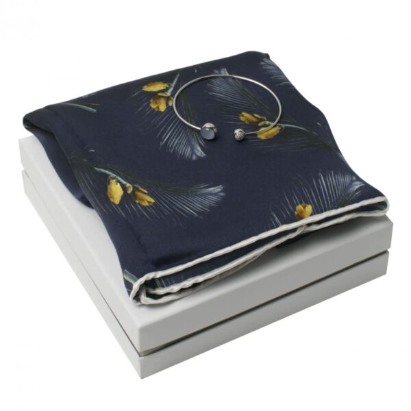 Navy floral scarf and silver bracelet on a white gift box.