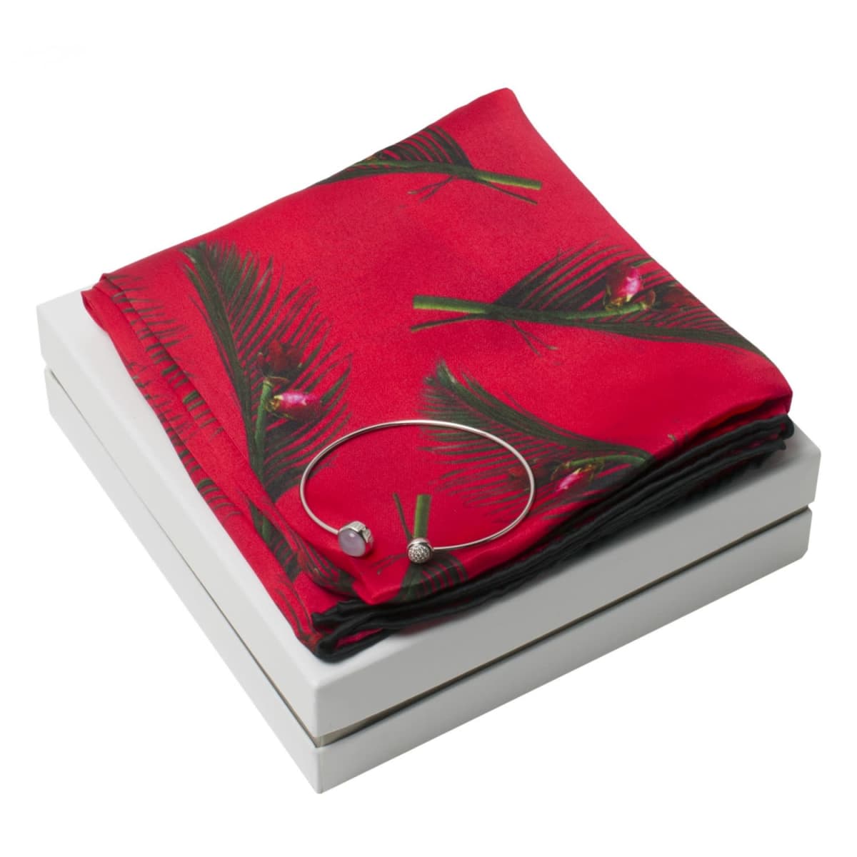 Red floral scarf and silver bracelet displayed on a white box against a white background.