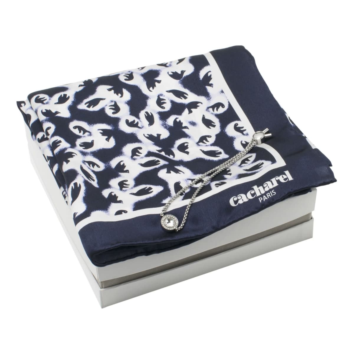 Navy and white patterned scarf with a silver bracelet on a white box.