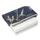 Navy floral scarf and gold bracelet displayed on a white box.