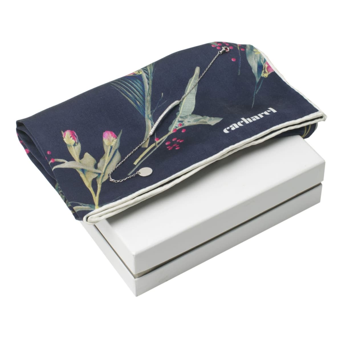 Navy floral scarf with cacharel text draped over a white gift box.