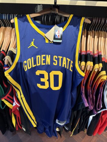 Steph Curry's $180 jersey: Blue Golden State with yellow number 30 hanging on a rack.