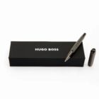 A black Hugo Boss pen and box with the cap placed beside the pen.