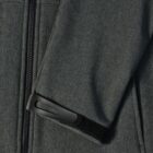 Close-up of a jacket sleeve with a zipper and adjustable velcro strap on the cuff.