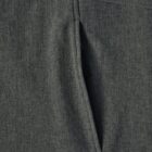Close-up of a gray fabric garment with a vertical zippered pocket.