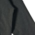 Close-up of a dark grey hoodie sleeve and pocket on a white background.
