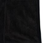 Close-up of a black fuzzy fabric jacket with a visible pocket and zipper on the side.