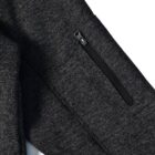 Dark gray sleeve with a black zipper pocket on textured fabric.