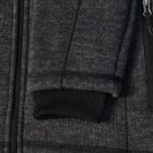 Close-up of a dark gray zip-up jacket sleeve with a black ribbed cuff.