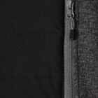 Close-up of a gray zipper on black and dark gray fabric.