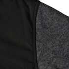 Close-up of a black padded vest over a heather gray knit long sleeve shirt.