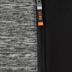 Close-up of a jacket zipper with a gray, black, and orange pull tab next to patterned fabric.