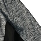 Close-up of a gray and black textured fabric, likely part of a sports jacket sleeve.