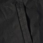 Close-up of a black fabric pocket with a vertical slit opening.