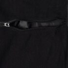 Close-up of a black fabric with a partially open horizontal zipper.