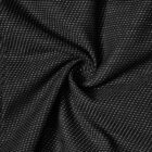 Black fabric with small white dots, gathered in a swirl pattern at the center.