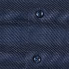 Close-up of a blue patterned fabric shirt with two dark blue buttons.