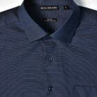 Dark blue dress shirt with small white dots, folded neatly with visible collar and buttons.