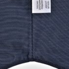 Navy blue fabric with white pinstripes and a clothing label showing material composition.
