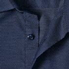 Close-up of a navy blue shirt with a small white dotted pattern and blue buttons.
