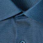Close-up of a blue dress shirt with a small white dotted pattern and blue button.