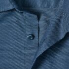 Close-up of a blue shirt with white dotted pattern and blue buttons.