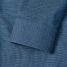 Blue dress shirt cuff with a small white dot pattern, viewed from above.
