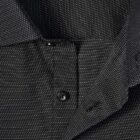 Close-up of a black shirt with small white dots and black buttons.