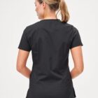 Woman with blonde ponytail wearing black short-sleeve top, shown from the back.