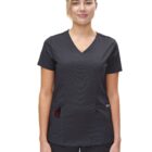 Woman in black medical scrubs standing and smiling with a pen in her pocket.