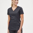 Smiling woman in black medical scrubs standing against a plain white background.