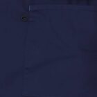 Close-up of a navy blue fabric pocket with a small black loop attached near the seam.