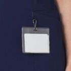 A blank name badge clipped to a dark navy uniform pocket.