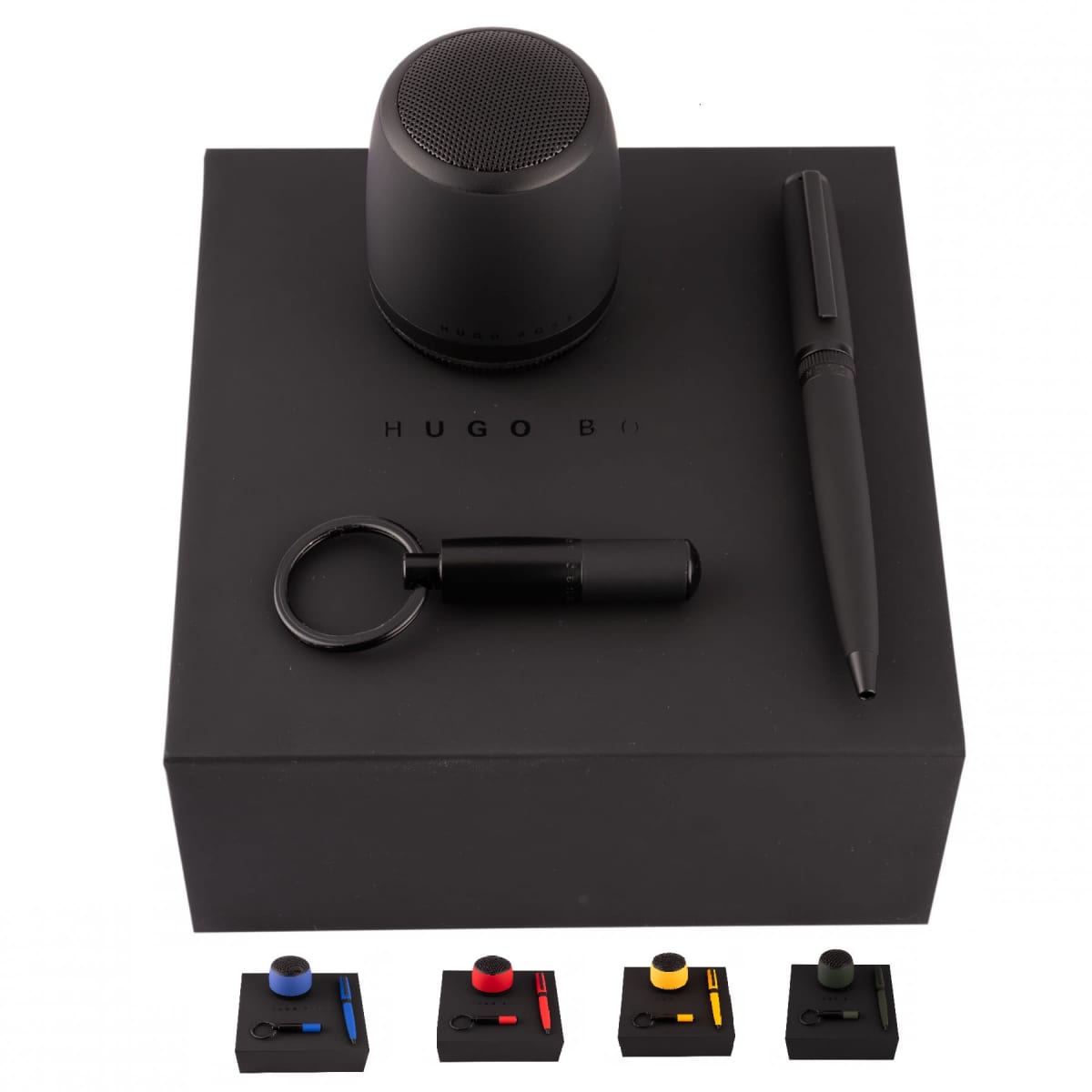 A black gift set with a speaker, pen, keychain, and colored accents on a black box.