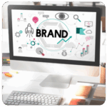 Computer screen displaying BRAND with marketing icons, highlighting key business goals.
