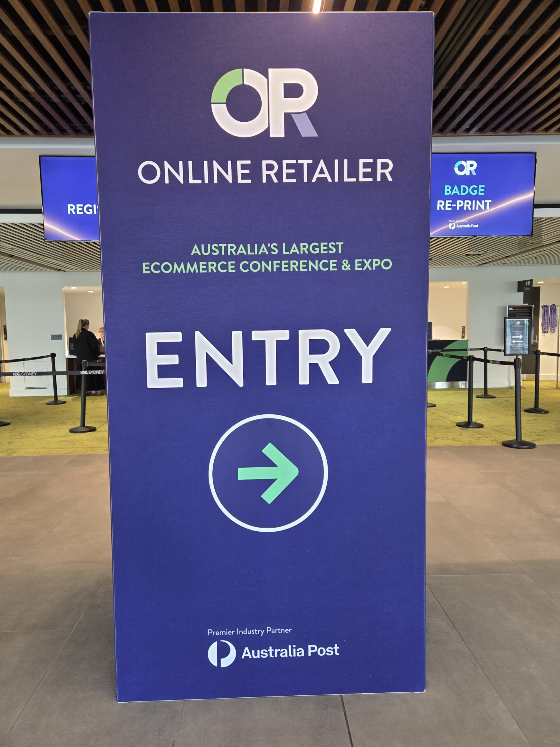 Large blue sign for ONLINE RETAILER ENTRY at the Online Retailer Conference Sydney 2025.