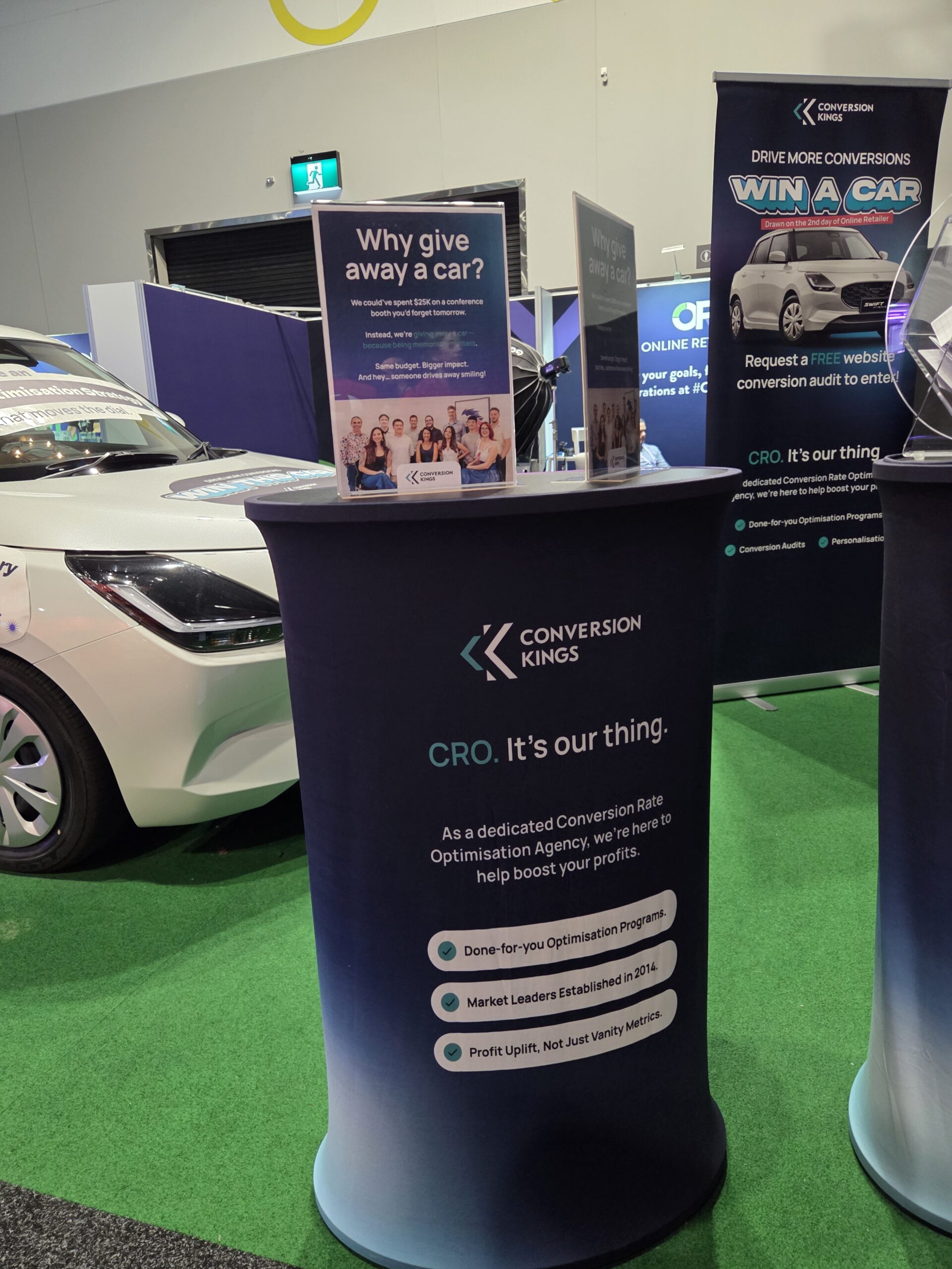 Exhibit booth at Online Retailer Conference Sydney 2025 with Conversion Kings display and car giveaway.